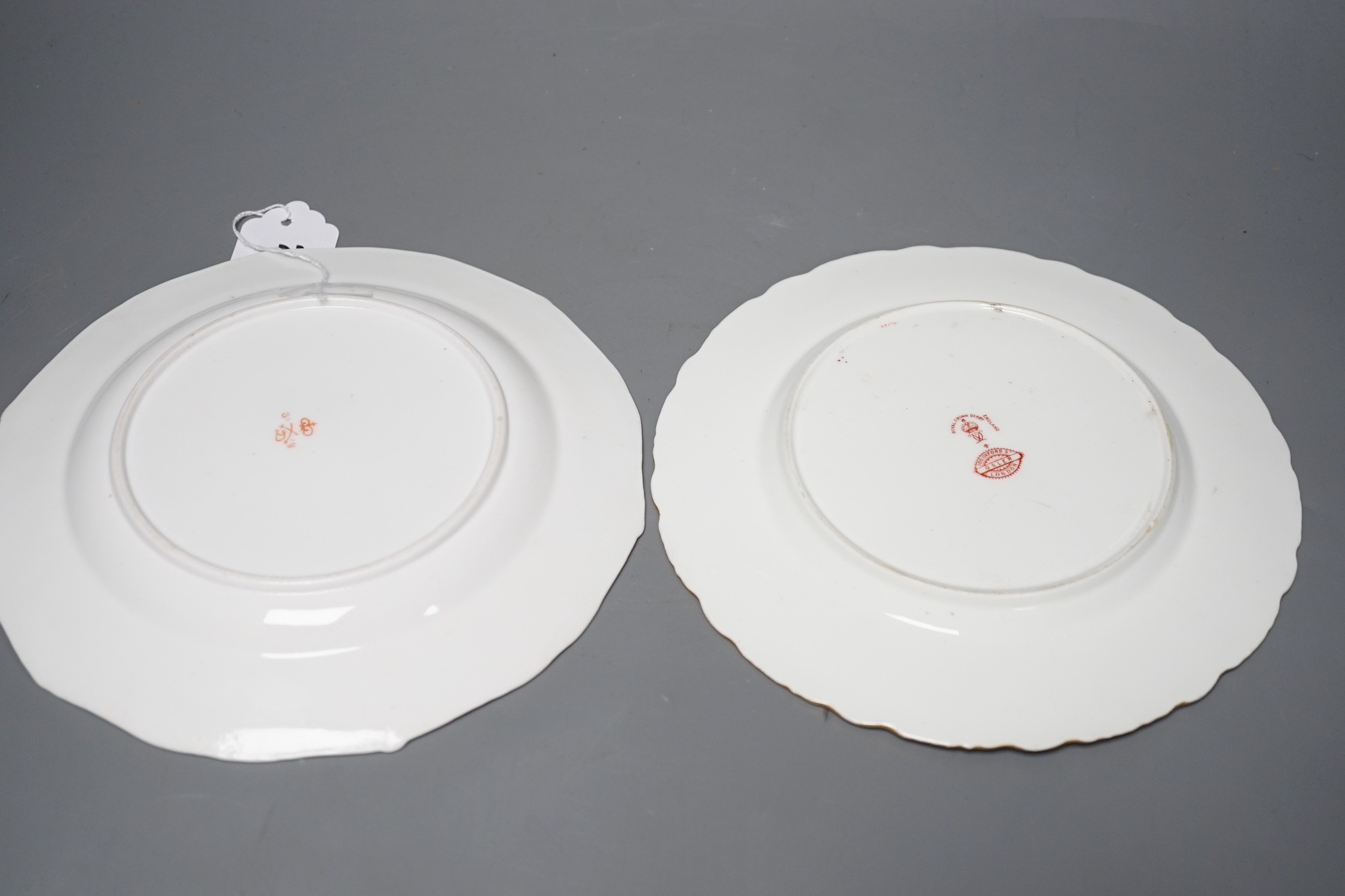 A Royal Crown Derby plate painted with fruit under claret ground by Cuthbert Gresley, signed, Made for Osler London, and a Derby King Street plate with roses